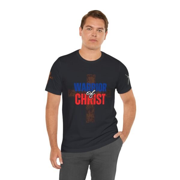 Black "Warrior of Christ" T-shirt featuring a bold distressed cross design with red, white, and blue lettering, representing faith, patriotism, and strength.