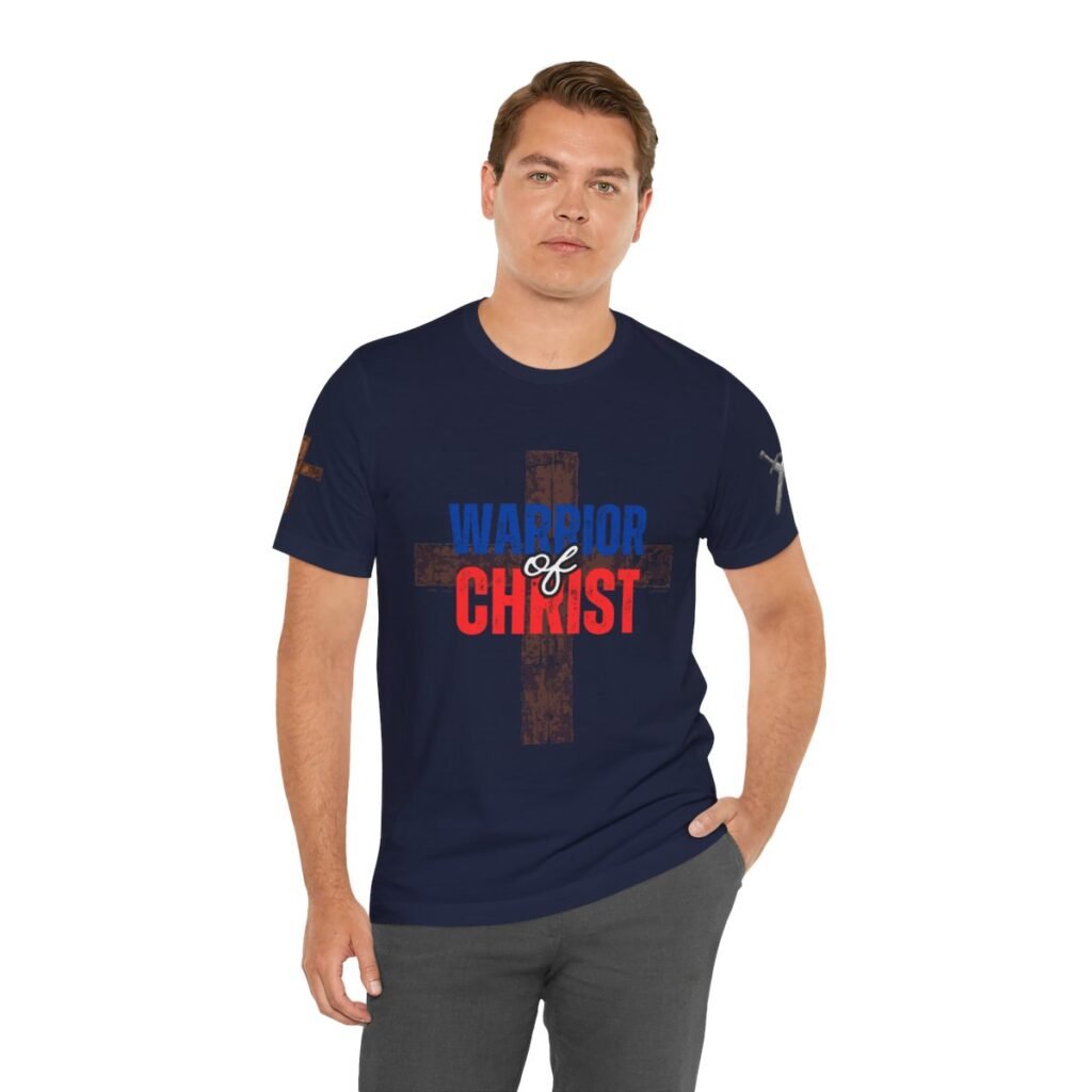 Navy blue "Warrior of Christ" T-shirt with a distressed cross design, featuring bold red and blue text.