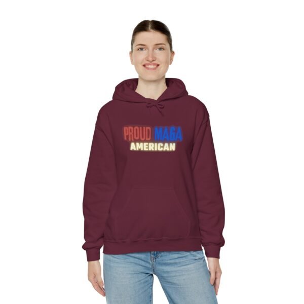 Burgundy "Proud MAGA American" hoodie with bold red, blue, and yellow text on the front, worn by a person to showcase patriotism.