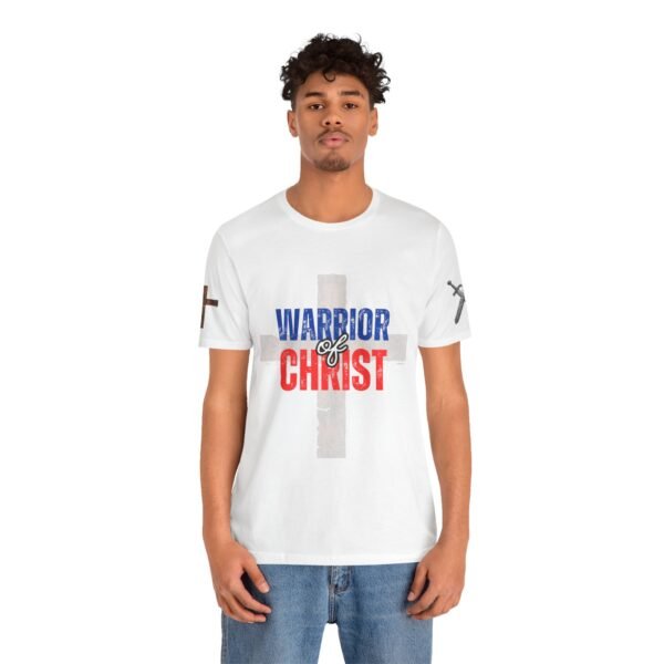 White "Warrior of Christ" T-shirt with a distressed cross and bold red, white, and blue lettering. Christian faith apparel for believers.